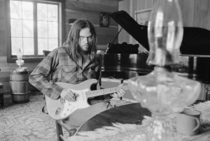 01 Jun 1973, Probably California, USA --- Neil Young Playing Guitar --- Image by © Henry Diltz/CORBIS