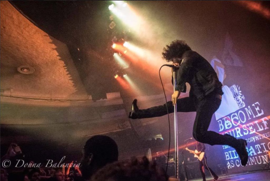 Los Angeles Press Club Cedric Bixler-Zavala of At The Drive-In leaps into the air during a performance at the Hollywood Palladium - Photo © 2016 Donna Balancia