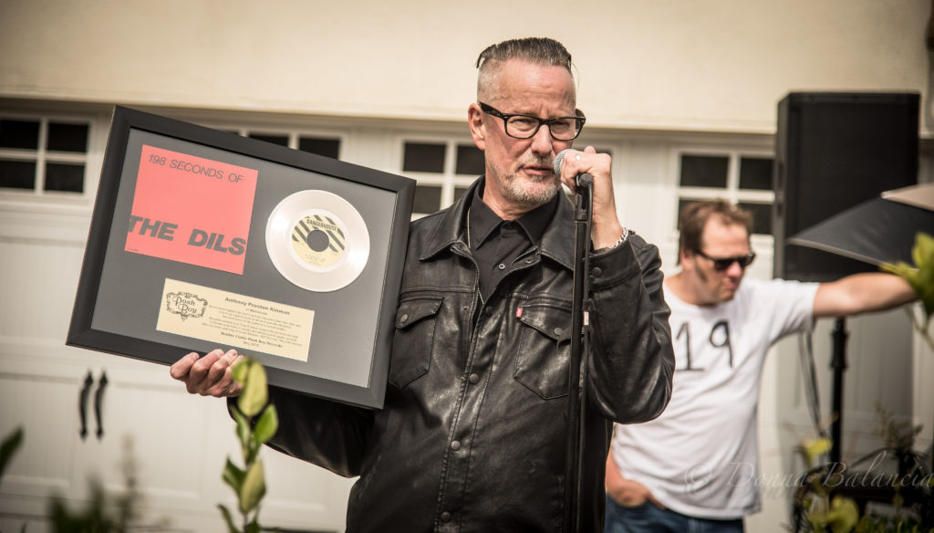 Chip holds up gold record of The Dils sent over by Posh Boy - Photo © 2018 Donna Balancia