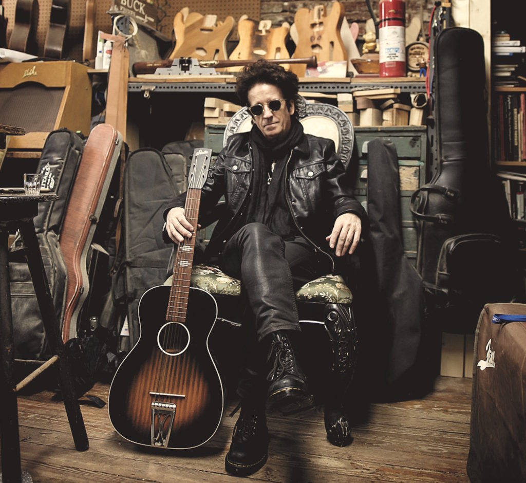 Willie Nile among the guitars - Photo by Christina Arrigoni