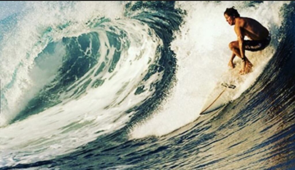 Stephan Jenkins surfing a big left hander - Courtesy image