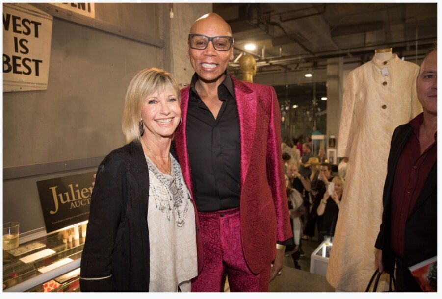 Olivia Newton-John's auction fetched more than $400,000. She is here with RuPaul - Miichelle Day